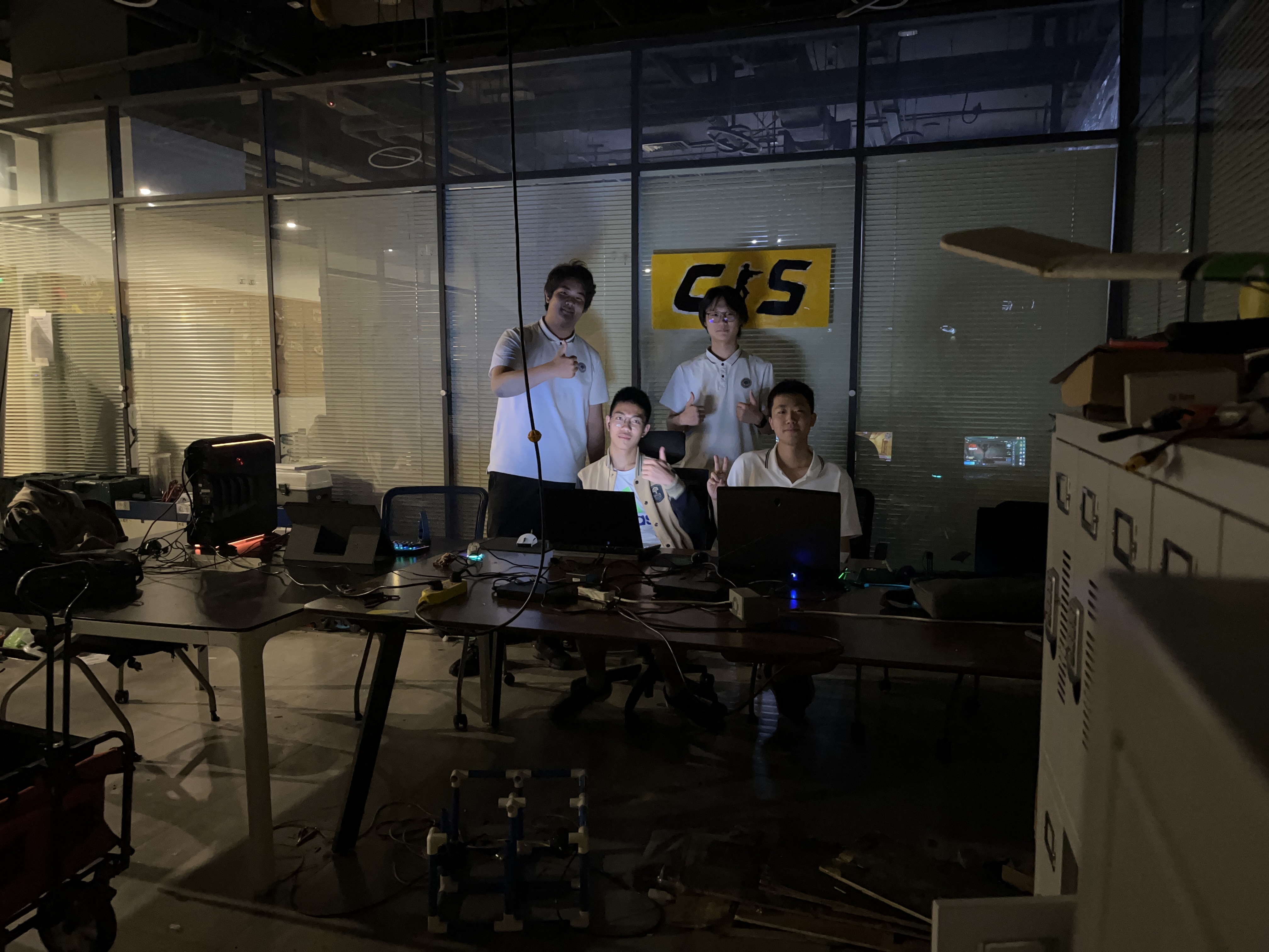 DJ facing a crowd at his deck. Photo with a purple hue
